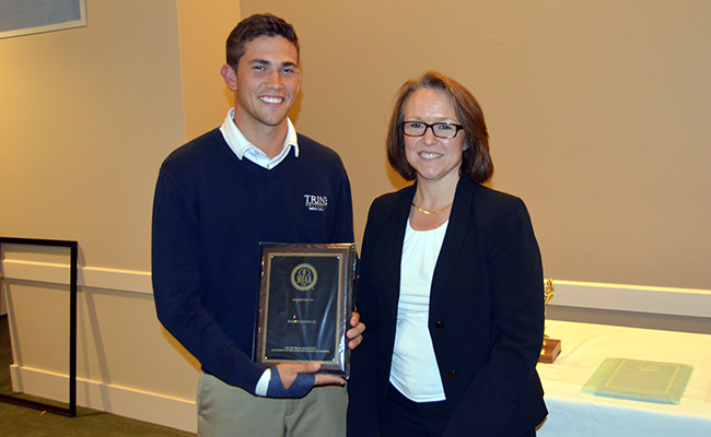 Brandon Snell receives the Sportsmanship Award from MIAA Commissioner, Penny Allen-Cook.